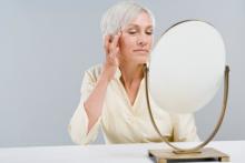 mature woman looking in mirror.jpg